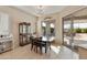 Dining area features a table with chairs, a display cabinet and a sliding glass door at 4439 E Ficus Way, Gilbert, AZ 85298