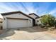 A charming home featuring a well-manicured lawn, a two-car garage, and an inviting front entrance at 4439 E Ficus Way, Gilbert, AZ 85298