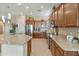 Open kitchen with central island, ample cabinets, and stainless steel refrigerator at 4439 E Ficus Way, Gilbert, AZ 85298