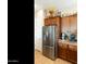 Kitchen with stainless steel fridge, matching appliances, and wooden cabinets at 4439 E Ficus Way, Gilbert, AZ 85298