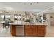 Kitchen with island, pendant lighting, stainless steel dishwasher, and adjacent dining area at 4439 E Ficus Way, Gilbert, AZ 85298