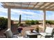 Comfortable patio with desert view, flowers and comfortable seating at 4439 E Ficus Way, Gilbert, AZ 85298