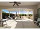 Covered patio with desert views, seating and a ceiling fan at 4439 E Ficus Way, Gilbert, AZ 85298