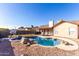 This backyard features a pool with rock features, landscaping, patio space, and perimeter fencing at 4507 E Towne Ln, Gilbert, AZ 85234