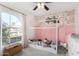 This bedroom features a unique bed frame, pink accents, and natural light at 4507 E Towne Ln, Gilbert, AZ 85234