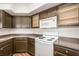 Kitchen with dark cabinets and white appliances at 4644 N 22Nd St # 1017, Phoenix, AZ 85016