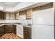 Kitchen with dark cabinets and white appliances at 4644 N 22Nd St # 1017, Phoenix, AZ 85016