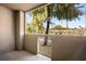 Covered patio with view of trees and parking lot at 4644 N 22Nd St # 1017, Phoenix, AZ 85016