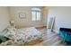 Bright bedroom with a comfortable bed and wood-look floors at 5840 S Pico St, Gilbert, AZ 85298