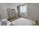 Bedroom with a queen bed, hanging chair, and decorative shelving at 5840 S Pico St, Gilbert, AZ 85298