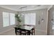 Bright dining room with a glass-top table and modern light fixture at 5840 S Pico St, Gilbert, AZ 85298