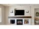 Modern fireplace with white stone and a dark wood mantel at 5840 S Pico St, Gilbert, AZ 85298