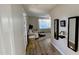 Light and airy hallway with wood-look floors and mirrors at 5840 S Pico St, Gilbert, AZ 85298