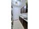 Well-lit laundry room with dark cabinetry and a utility sink at 5840 S Pico St, Gilbert, AZ 85298