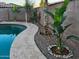 Landscaped pool area with string lights and tropical plants at 5840 S Pico St, Gilbert, AZ 85298