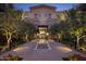 Attractive building exterior with courtyard and fountain at night at 6166 N Scottsdale Rd # C2008, Paradise Valley, AZ 85253