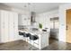 Modern kitchen with island and white cabinets at 6166 N Scottsdale Rd # C2008, Paradise Valley, AZ 85253