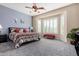 Main bedroom with ceiling fan, large window, and ensuite bathroom at 6615 W Sandpiper Ct, Florence, AZ 85132