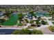 Aerial view of a community park with a pond, playground and shaded seating areas at 6615 W Sandpiper Ct, Florence, AZ 85132