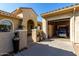 Tan house exterior, with a golf cart in the garage, and walkway at 6615 W Sandpiper Ct, Florence, AZ 85132