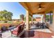 Covered patio with seating area and golf course view at 6615 W Sandpiper Ct, Florence, AZ 85132