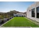 Artificial turf backyard with stepping stones and modern fence at 7130 E Saddleback St # 11, Mesa, AZ 85207