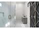 Modern bathroom with marble shower, gray vanity, and gold fixtures at 7130 E Saddleback St # 11, Mesa, AZ 85207