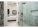 Spa-like bathroom with a glass shower, marble tile, and a glimpse of bedroom at 7130 E Saddleback St # 11, Mesa, AZ 85207