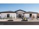 Stunning modern home with desert landscaping and a paved walkway at 7130 E Saddleback St # 11, Mesa, AZ 85207