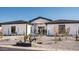 White modern home with gray roof and drought-tolerant landscaping at 7130 E Saddleback St # 11, Mesa, AZ 85207