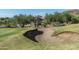 Sand trap on a lush green golf course with desert landscape in the background at 7130 E Saddleback St # 11, Mesa, AZ 85207