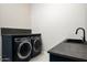 Well-appointed laundry room with dark cabinetry and a stylish sink at 7130 E Saddleback St # 11, Mesa, AZ 85207