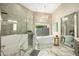 Elegant bathroom with soaking tub and marble floors at 7439 E Beryl Ave, Scottsdale, AZ 85258