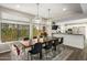 Dining room with a rustic wooden table and modern black chairs at 7439 E Beryl Ave, Scottsdale, AZ 85258