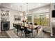 Bright dining room features a wood table, black chairs, and large windows at 7439 E Beryl Ave, Scottsdale, AZ 85258