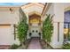 Elegant entryway with double doors and lush landscaping at 7439 E Beryl Ave, Scottsdale, AZ 85258