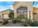 Tan two-story home with a tile roof, landscaping, and a two-car garage at 7439 E Beryl Ave, Scottsdale, AZ 85258