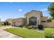 Tan two-story home with a tile roof, landscaping, and a two-car garage at 7439 E Beryl Ave, Scottsdale, AZ 85258