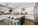 Modern kitchen with white cabinets, quartz countertops, and a large island at 7439 E Beryl Ave, Scottsdale, AZ 85258