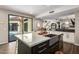 Modern kitchen with a large island, farmhouse sink, and access to the backyard at 7439 E Beryl Ave, Scottsdale, AZ 85258