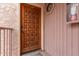 Wood front door with a decorative panel design at 7510 E Thomas Rd # 234, Scottsdale, AZ 85251