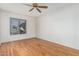 Light and airy bedroom with wood flooring and a window at 753 W Pampa Ave, Mesa, AZ 85210