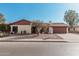 Ranch-style house featuring a red garage door and mature tree at 753 W Pampa Ave, Mesa, AZ 85210