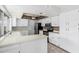 L-shaped kitchen with white cabinets and tile floors at 753 W Pampa Ave, Mesa, AZ 85210