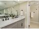 Double vanity bathroom with gray cabinets, white countertops, and modern fixtures at 7605 E Via De Lindo --, Scottsdale, AZ 85258