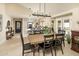 Bright dining room with large wooden table and black chairs, adjacent to kitchen at 7605 E Via De Lindo --, Scottsdale, AZ 85258