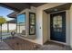 Front entry with modern black door and sidelights, and a small cactus garden at 7605 E Via De Lindo --, Scottsdale, AZ 85258