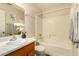 Bright bathroom with a shower-tub combo, sleek vanity, and contemporary finishes at 8553 N 112Th Ave, Peoria, AZ 85345