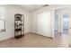 A bedroom featuring tile floor and a closet, with access to a full bathroom at 8553 N 112Th Ave, Peoria, AZ 85345