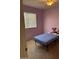 Small bedroom with a twin bed, ceiling fan, and purple walls at 8553 N 112Th Ave, Peoria, AZ 85345